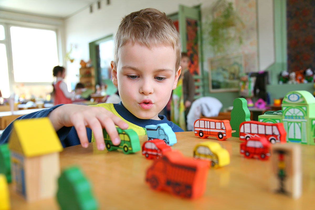 Young Boy Playing With Toys.