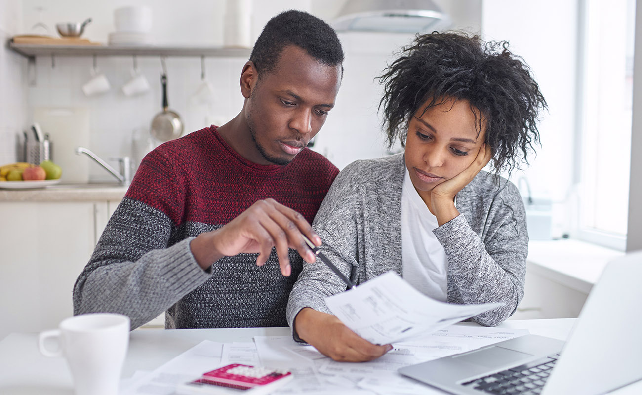 Couple calculating expenses together.