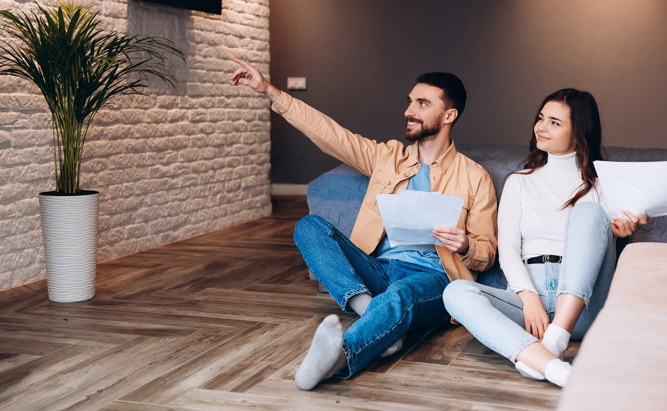 Couple examining spacious house.