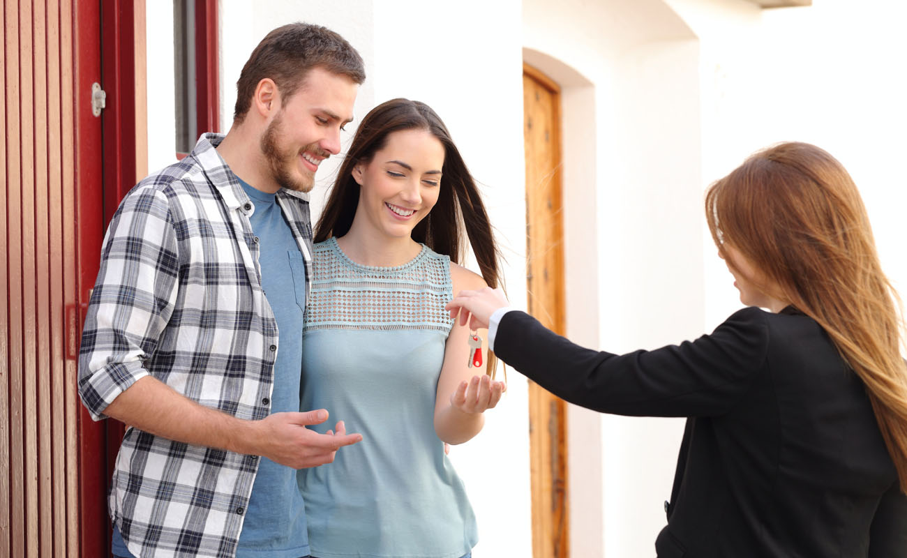 Couple getting keys to a new house.
