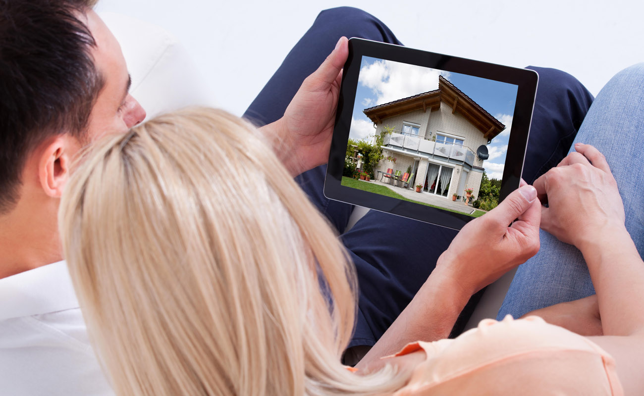 Couple looking at houses online.