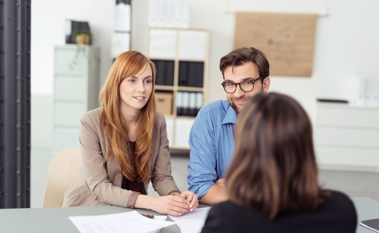 Couple talking to a loan offices.