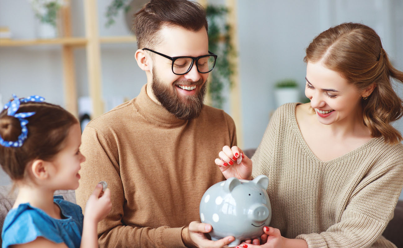 Family placing money on piggybank.