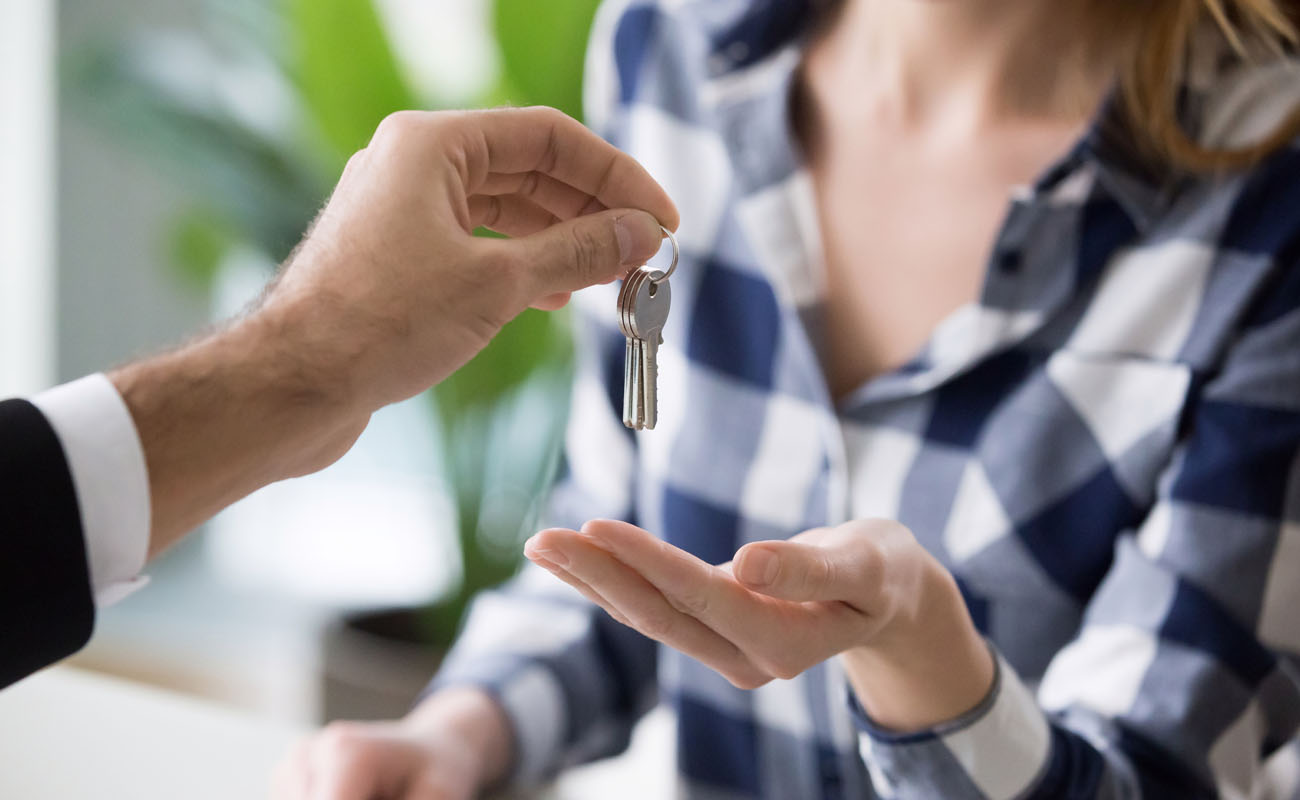 Giving keys to a lady homeowner.