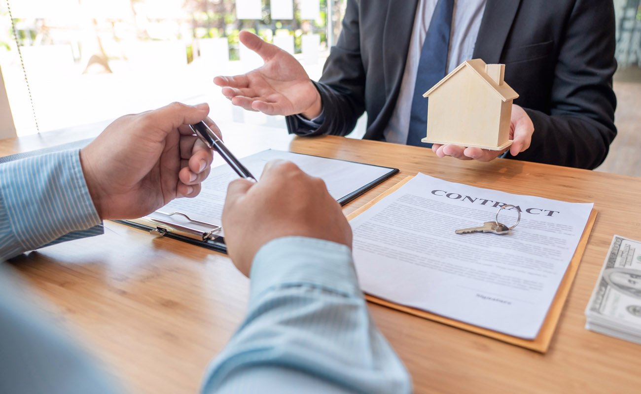 Real estate agent explaining contract to buyers.