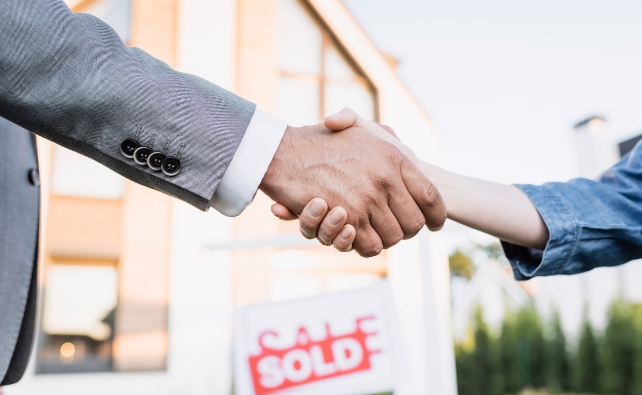 Shaking hands with real estate agent.