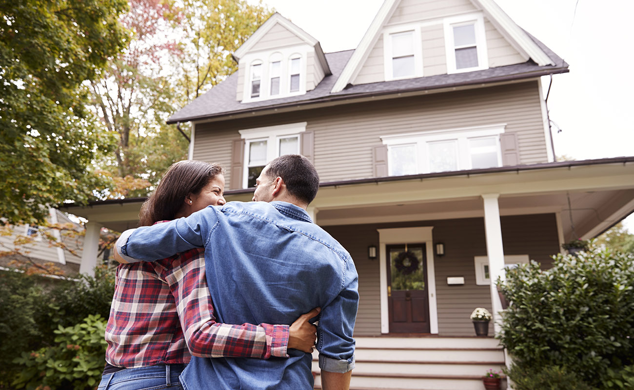 Sweet couple checking out a house.