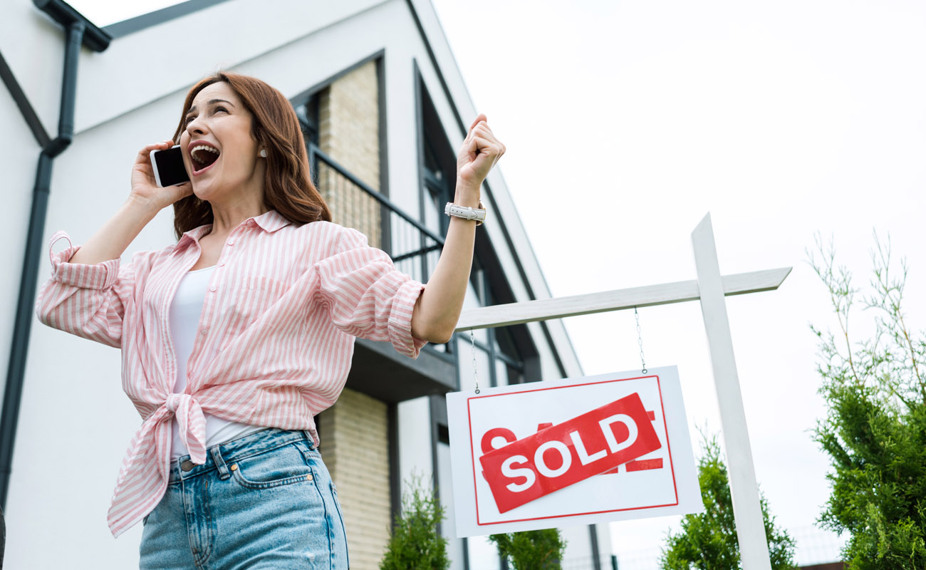 Woman happy over sold house.